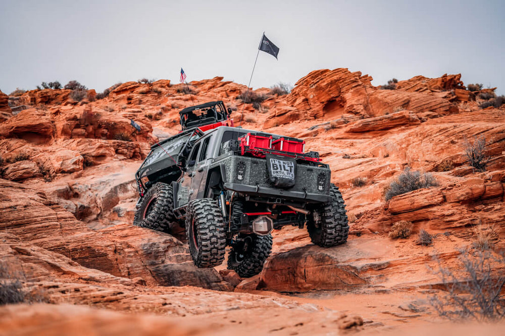AlumiBOB driving over red rock on a trail